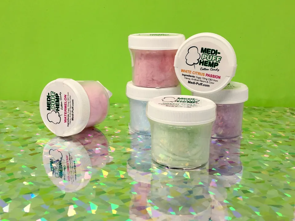 Jars of hemp-derived CBD products stacked on a holographic surface