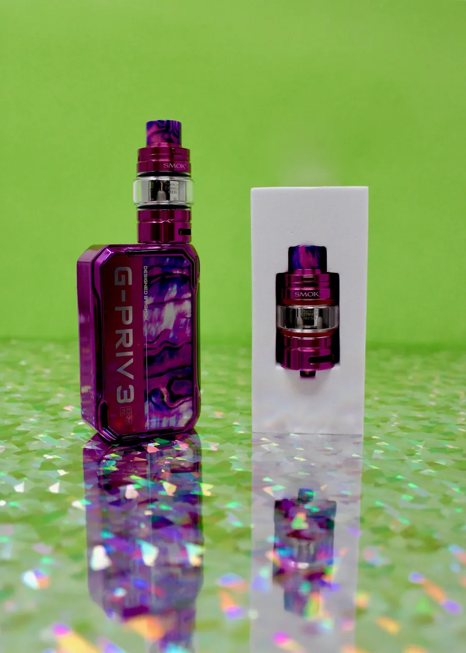 Pink camo box mod and tank next to its box